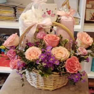Baby girl flower basket with roses, spray roses, limonium, asters, lisianthus and Italian Ruscus