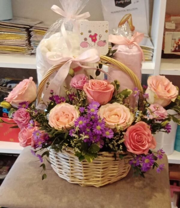 Baby girl flower basket with roses, spray roses, limonium, asters, lisianthus and Italian Ruscus