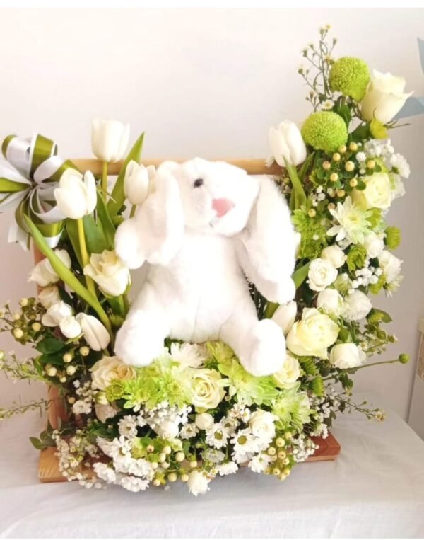 Floral bunny arrangement with tulips, roses, chrysanthemums, lisianthus, hypericum, spray roses, asters, baby’s breath, ruscus and ferns