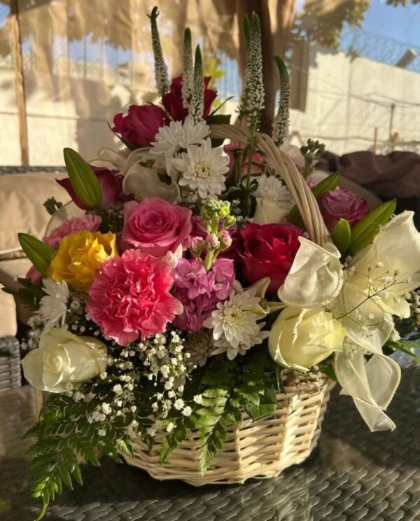 Large floral basket arrangement with Veronica spuria, carnations, roses, matthiola, chrysanthemums, baby’s breath, lilies and ferns