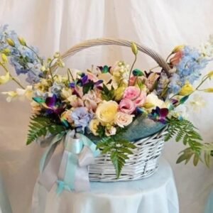 Large basket flower arrangement with matthiola, orchids, alstroemeria, roses, lisianthus, delphinium and ferns