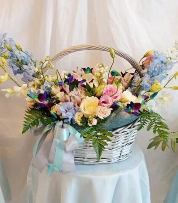 Large basket flower arrangement with matthiola, orchids, alstroemeria, roses, lisianthus, delphinium and ferns