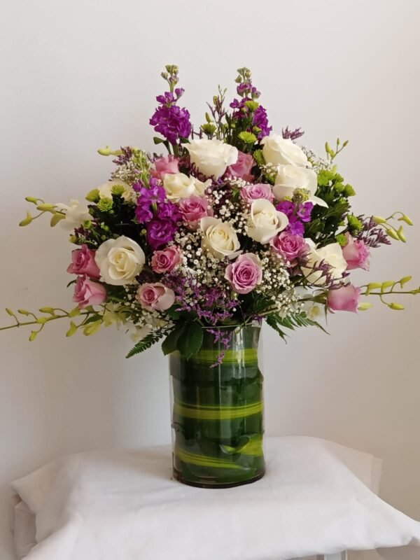 Medium vase arrangement with roses, orchids, greenery and baby’s breath – MuscatFnC