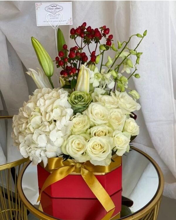 Medium square box floral arrangement with hydrangeas, roses, lilies, cabbage flowers, orchids and hypericum berries
