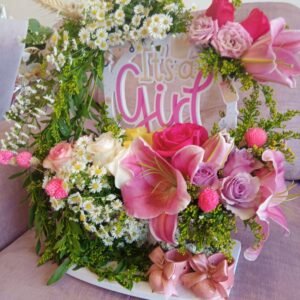 Medium floral stand with lilies, asters, solidaster, roses, spray roses and ceramic baby boots